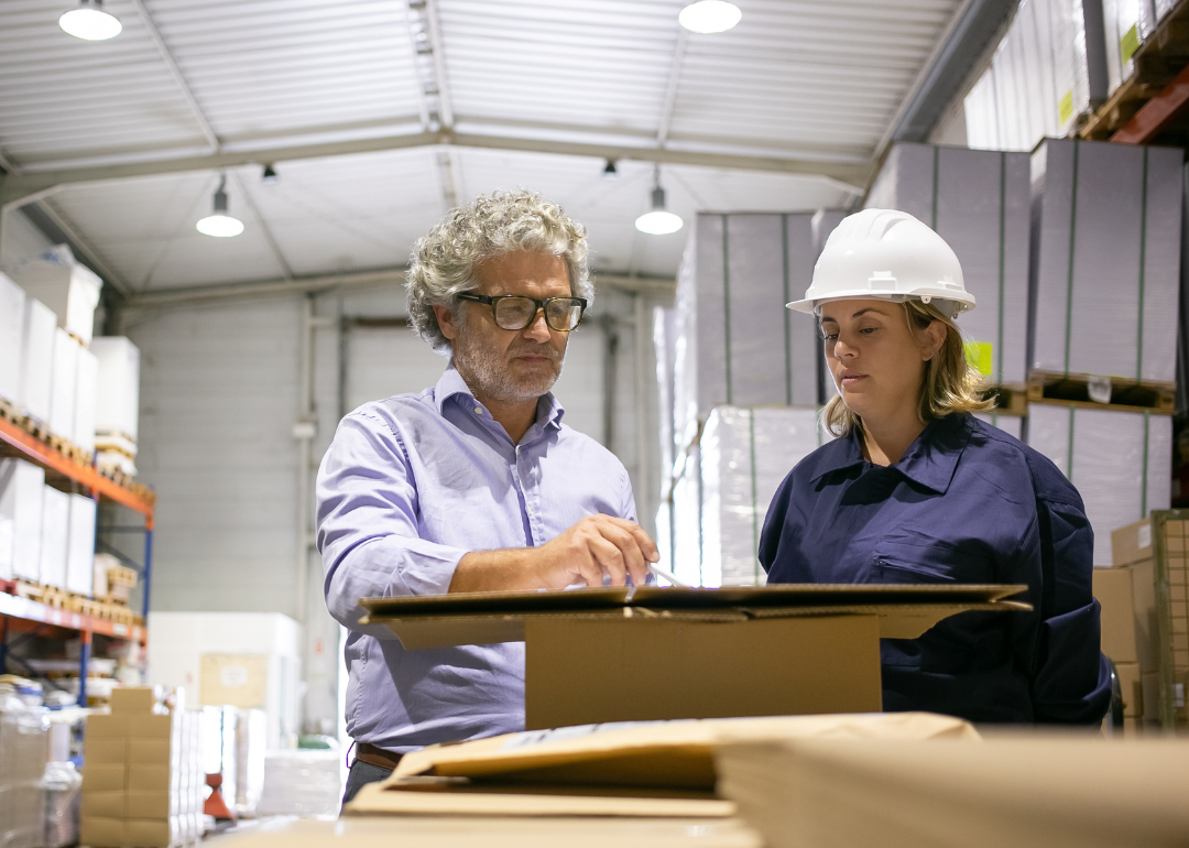 Man consulting with logistics employee.