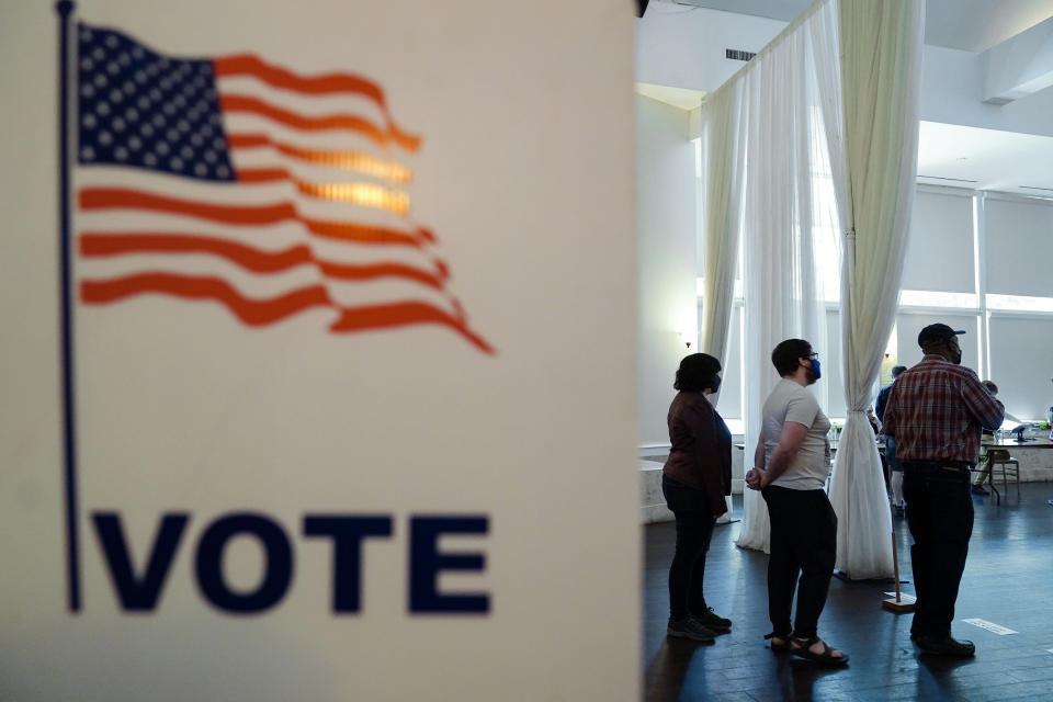 People wait in line to vote in the Georgia's primary election on Tuesday, May 24, 2022, in Atlanta. (AP Photo/Brynn Anderson)