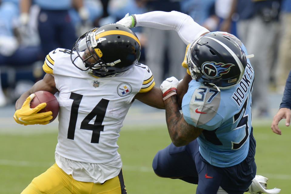 Tennessee Titans safety Amani Hooker (37) tries to bring down Pittsburgh Steelers wide receiver Ray-Ray McCloud (14) in the first half of an NFL football game Sunday, Oct. 25, 2020, in Nashville, Tenn. (AP Photo/Mark Zaleski)