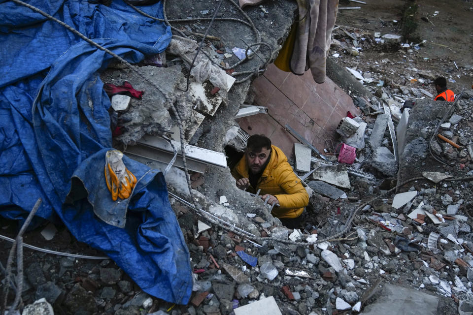 <p>A man searches for people in a destroyed building in Adana, Turkey, Monday, Feb. 6, 2023. A powerful quake has knocked down multiple buildings in southeast Turkey and Syria and many casualties are feared. (AP Photo/Khalil Hamra)</p> 