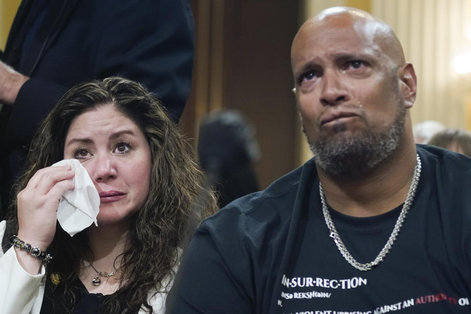 U.S. Capitol Police Sgt. Harry Dunn, right, and Sandra Garza, the long-time partner of Capitol Hill Police Officer Brian Sicknick who died shortly after the Jan. 6 attack, left, react as a video of the Jan. 6 attack on the U.S. Capitol is played during a public hearing of the House select committee investigating the attack is held on Capitol Hill, Thursday, June 9, 2022, in Washington. (AP Photo/Andrew Harnik)