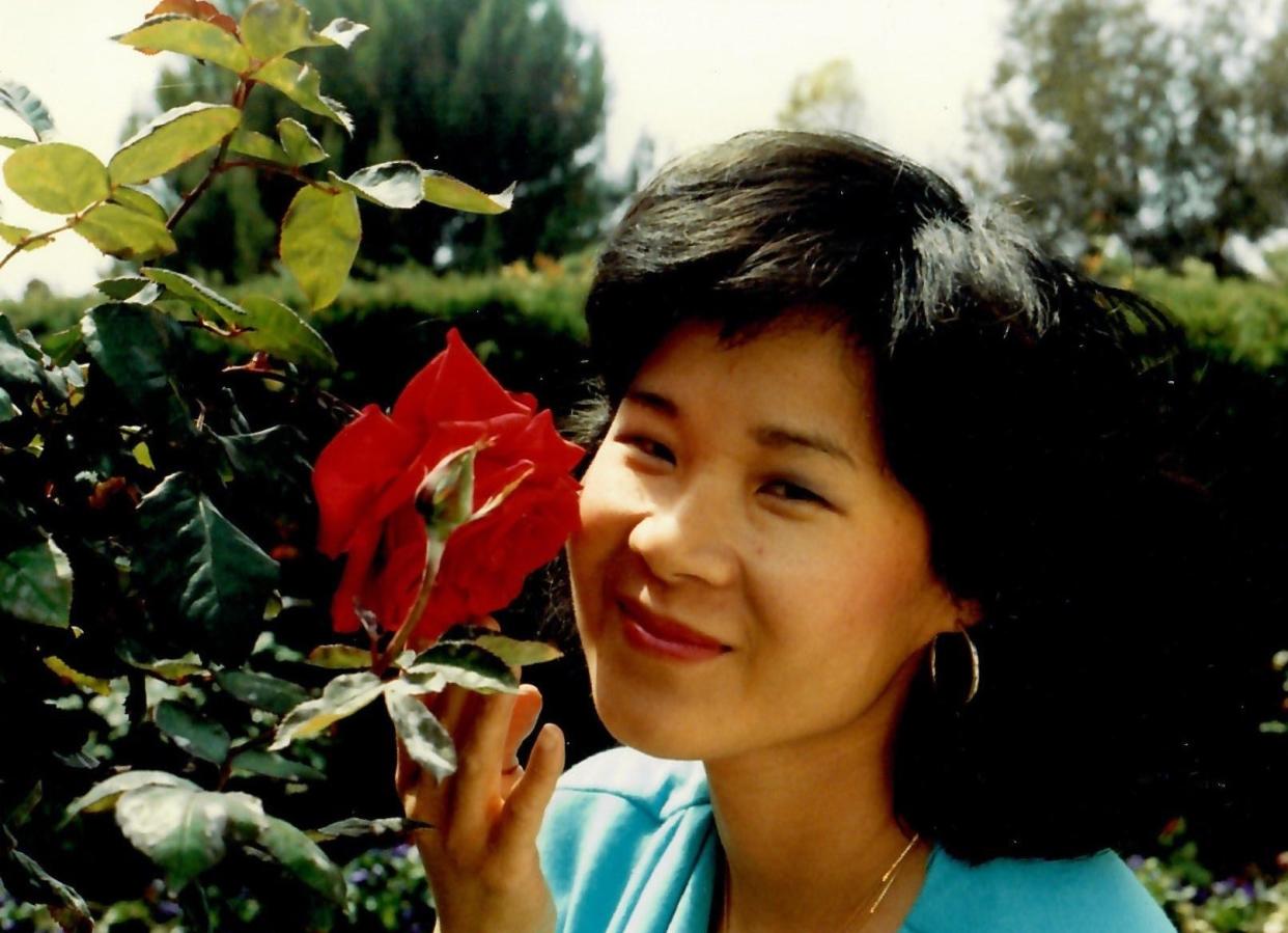 Yvonne Liu at age 30 holding a red flower