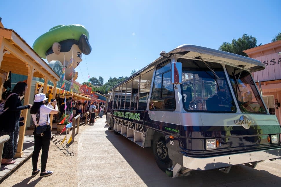 Guests standing around the Studio Tour tram at Jupiter's Claim set at Universal Studios Hollywood.