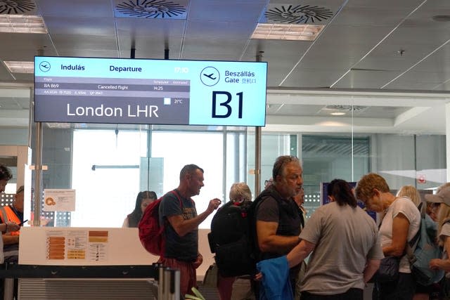 Passengers wait at a departure gate at Ferenc Liszt International Airport in Budapest, Hungary, as flights to the UK and Ireland were cancelled 