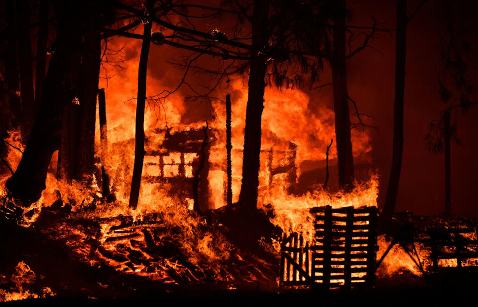 <p>A structure burns as flames rage out of control in the Santa Cruz Mountains near Loma Prieta, California on September 27, 2016. The Loma Prieta Fire has charred more than 1,000 acres and burned multiple structures in the area. (Josh Edelson/AFP/Getty Images) </p>