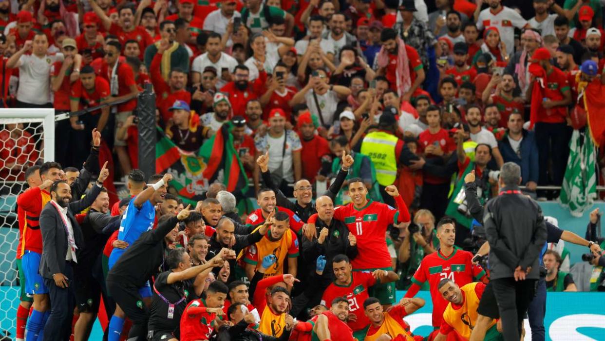 Morocco's players celebrate after winning the Qatar 2022 World Cup quarter-final football match between Morocco and Portugal at the Al-Thumama Stadium in Doha on December 10, 2022. (Photo by Odd ANDERSEN / AFP)