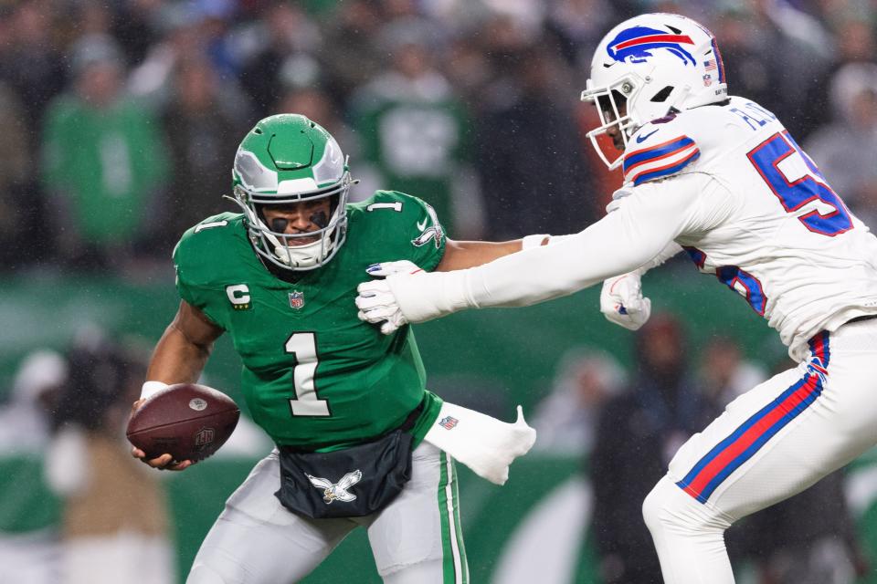 Nov 26, 2023; Philadelphia, Pennsylvania, USA; Philadelphia Eagles quarterback Jalen Hurts (1) eludes Buffalo Bills defensive end Leonard Floyd (56) during the first quarter at Lincoln Financial Field. Mandatory Credit: Bill Streicher-USA TODAY Sports