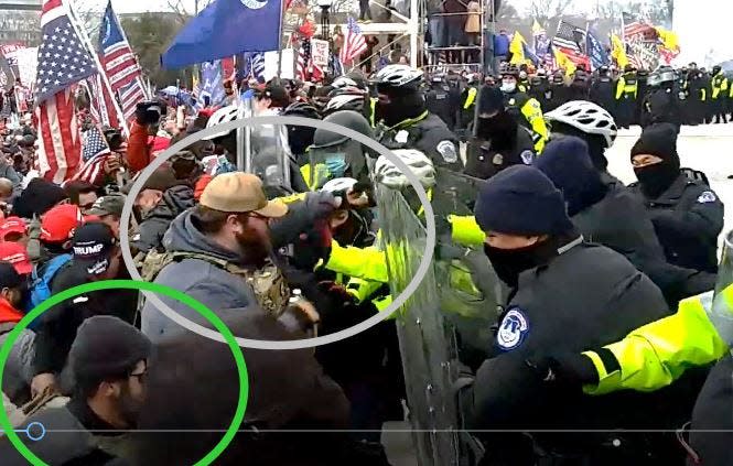 Joseph Hutchinson, in gray circle, is allegedly shown fighting with officers outside the U.S. Capitol on Jan. 6,  in an image from a federal arrest affidavit. Joshua Doolin is identified inside the green circle.