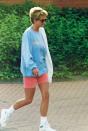 <p>Diana went for contrast with her blue and orangey-red outfit, though always opted for neutral accessories. Case in point? Her white sneakers and tortoise shell sunglasses. </p>