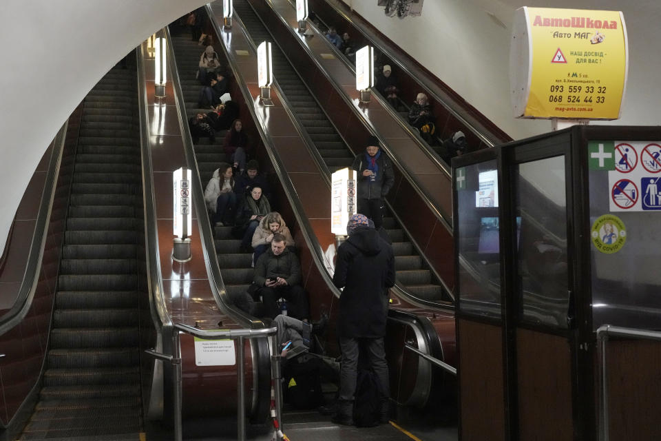 People rest in the subway station being used as a bomb shelter during a rocket attack in Kyiv, Ukraine, Thursday, Dec. 29, 2022. (AP Photo/Efrem Lukatsky)