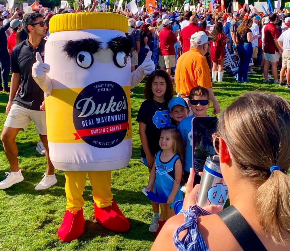 Fans pose with the Duke’s Mayo mascot while gathering to watch ESPN College GameDay on Saturday morning ahead of the Duke’s Mayo Classic, featuring UNC vs. South Carolina, in Charlotte, NC. Andrew Carter/News & Observer