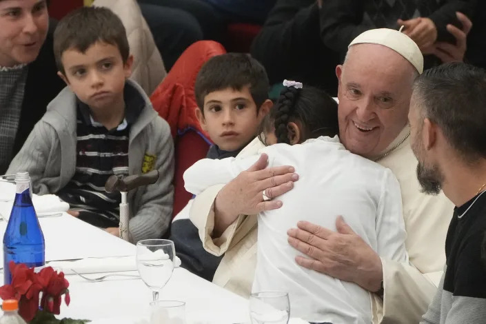 Pope Francis is cheered by faithful as he arrives for a lunch at the Vatican, Sunday, Nov. 13, 2022. Francis celebrated the Catholic Church's World Day of the Poor by inviting hundreds of poor and homeless people and migrants into the Vatican for a special Mass and luncheon. (AP Photo/Gregorio Borgia)