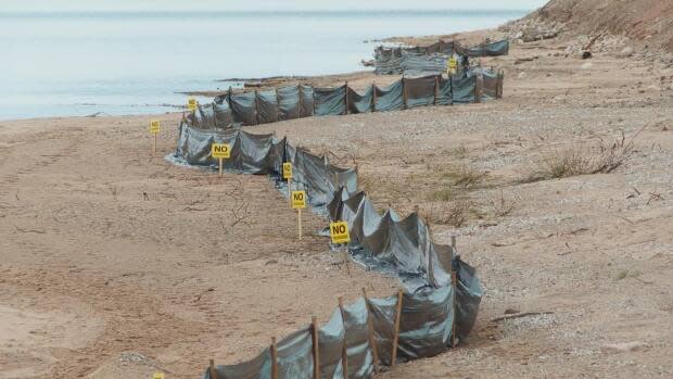 The park's developer Stirling Group has lined the beach portion of the park with black silt shield; a barrier to keep construction debris out of the water. The signs also keep walkers a safe distance from the site.