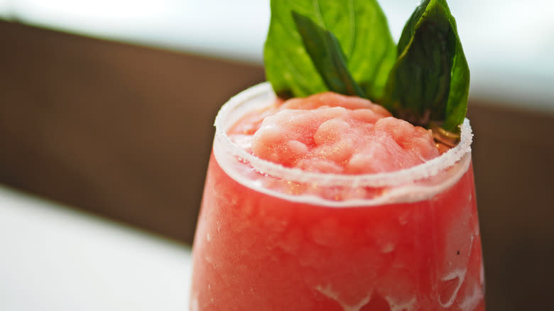 red slushie in glass with garnish