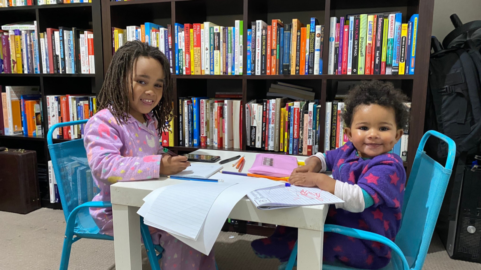 Prosper's kids Kaliyah, 8, and Alania, 4 reading books.