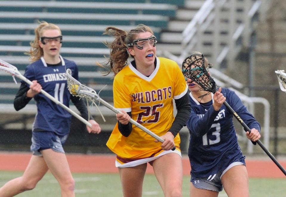 Weymouth's Megan Doyle, center, races to the net as Cohasset defenders Reese Hansen, left, and Rorie Newman, right, pursue during girls lacrosse at Weymouth High School, Friday, March 31, 2023.