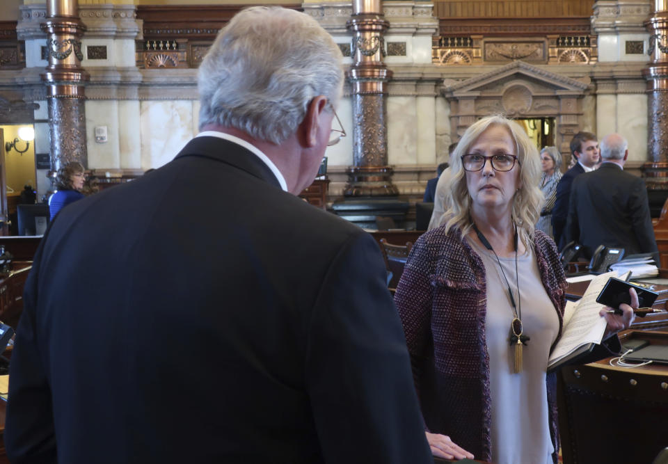 Kansas state Sen. Mary Pilcher-Cook, right, R-Shawnee, confers with Senate health committee Chairman Gene Suellentrop, R-Wichita, before a vote on an anti-abortion bill that they both support, Friday, April 5, 2019, at the Statehouse in Topeka, Kansas. The bill requires abortion providers to tell women using medication to end their pregnancies that the process can be reversed after they take the first of two pills. (AP Photo/John Hanna)
