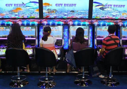 Visitors play a game during the G2E Asia gaming expo in Macau on May 23. As billions of dollars pour into Asia's gleaming casinos, they are becoming the front line of a sometimes hugely lucrative battle between cheats and the house, say experts