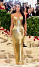 <p>Looking every inch the Hollywood A-lister, Kim Kardashian stopped crowds when she arrived in this Versace gold column dress. Photo: Getty Images </p>