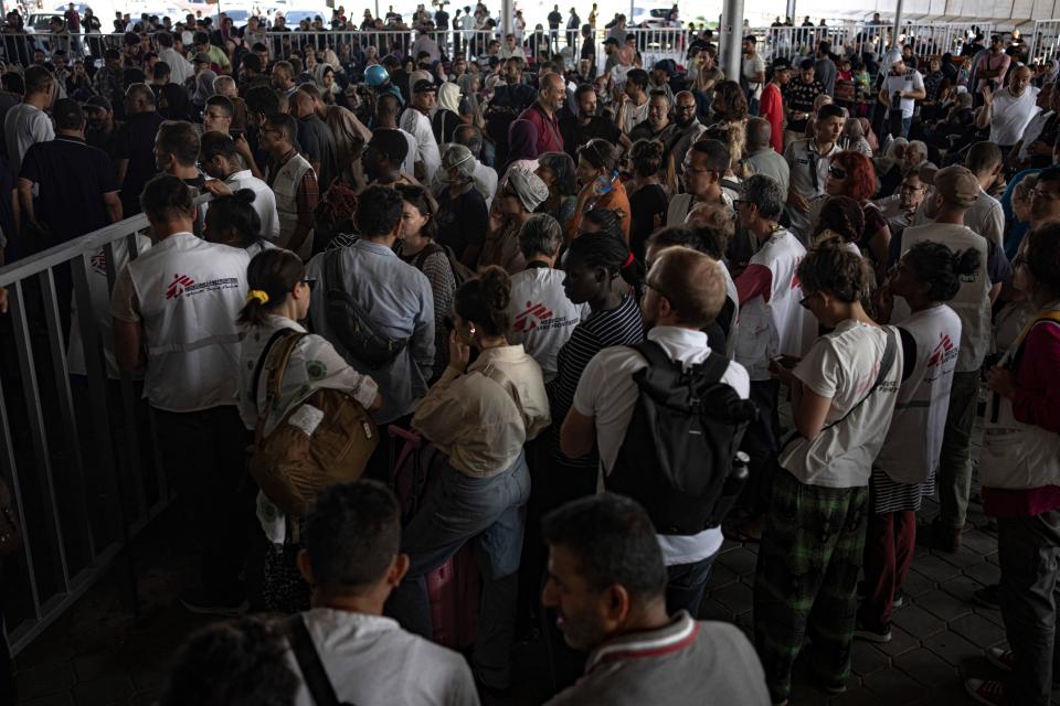 Palestinians and foreign aid workers wait to cross into Egypt at Rafah, Gaza Strip (Copyright 2023 The Associated Press. All rights reserved.)