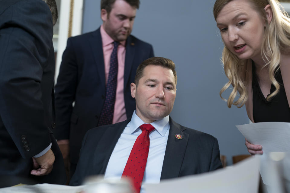 Rep. Guy Reschenthaler, R-Pa., confers with an aide as the House Rules Committee meets to prepare Speaker Kevin McCarthy's debt ceiling package for the floor, on Capitol Hill in Washington, Tuesday, April 25, 2023. Reschenthaler serves as Speaker McCarthy's chief deputy whip in the Republican Conference. (AP Photo/J. Scott Applewhite)