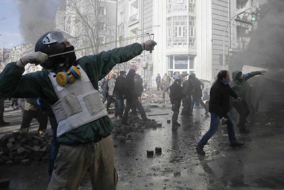 Anti-government protesters clashes with riot police outside Ukraine's parliament in Kiev, Ukraine, Tuesday, Feb. 18, 2014. Some thousands of anti-government protesters clashed with police in a new eruption of violence Tuesday. (AP Photo/Efrem Lukatsky)
