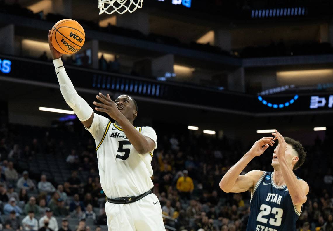 Missouri Tigers guard D’Moi Hodge (5) drives to basket past Utah State Aggies forward Taylor Funk (23) during a game for the NCAA Tournament at Golden 1 Center in Sacramento, Thursday, March 16, 2023.