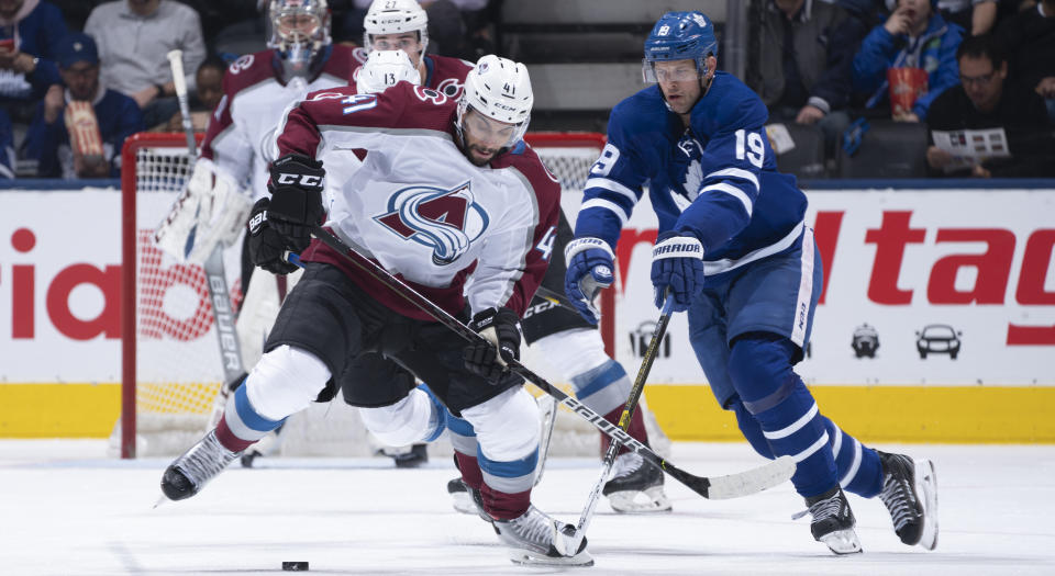 Jason Spezza of the Toronto Maple Leafs battles for the puck against Pierre-Edouard Bellemare of the Colorado Avalanche during the second period of Wednesday's game at the Scotiabank Arena. (Photo by Mark Blinch/NHLI via Getty Images)