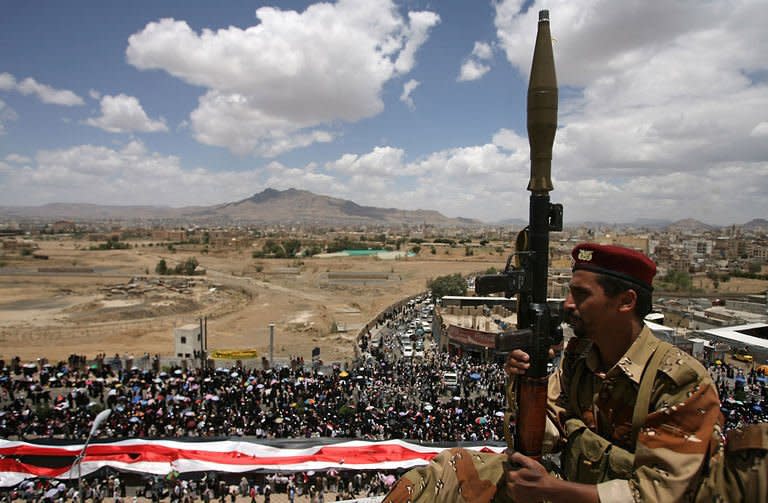 A Yemeni army soldier stands guard in Sanaa during a parade by anti-government protesters. A Gulf mediator flew out on Sunday after failing to secure Yemeni President Ali Abdullah Saleh's signature on a transition deal for him to quit office, although his ruling party signed the accord