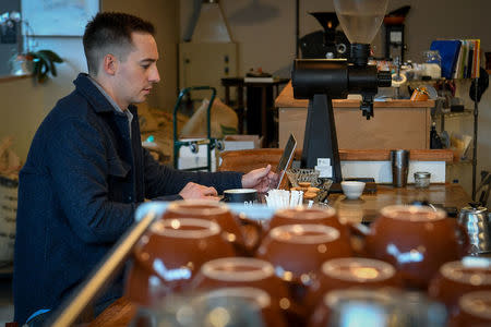 Dr. Michael Elliott, 31, an emergency room physician at University of Kentucky Hospital, sits at a coffee shop in Lexington, KY, U.S., February 7, 2018. REUTERS/Bryan Woolston/Files