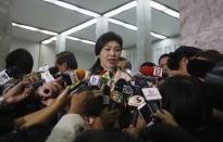 Thailand's Prime Minister Yingluck Shinawatra speaks to reporters following the declaration of a state of emergency in Bangkok January 21, 2014. REUTERS/Athit Perawongmetha