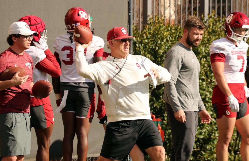 Defensive coordinator Ted Roof works with players during OU's first spring football practice Tuesday in Norman.