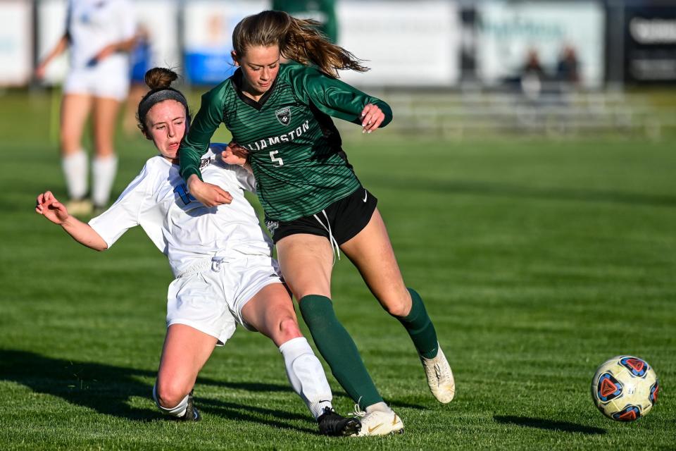 Williamston's Ella Kleiver, right, and Okemos' Allison Korb go after the ball during the first half on Tuesday, May 17, 2022, at Williamston High School. 