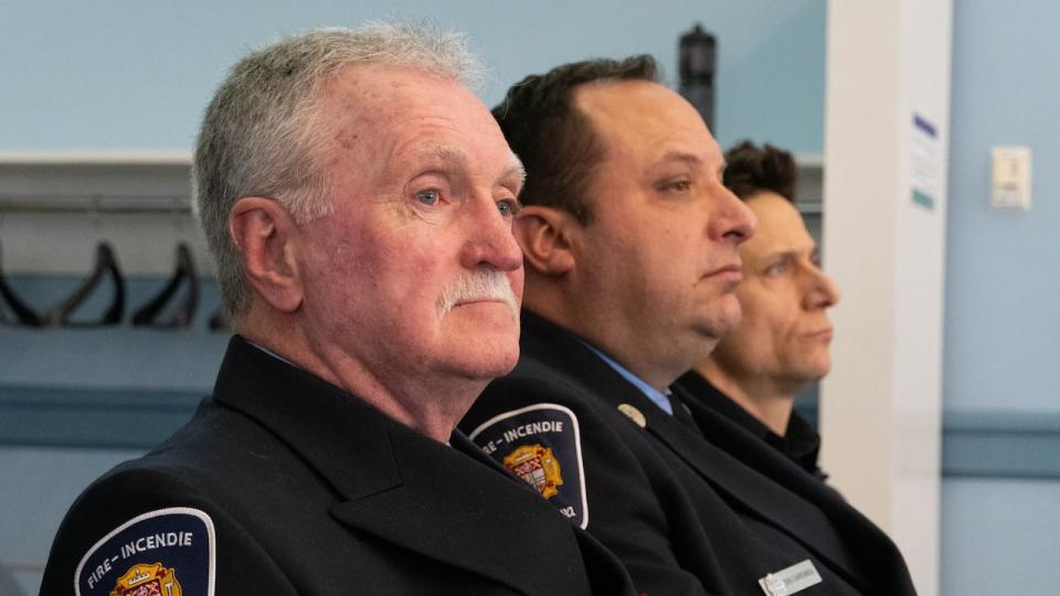 Chris Burke, left, a rural firefighter based in Dunrobin, sits with his colleagues at a meeting of Ottawa's emergency preparedness and protective services committee on Thursday, Feb. 15. (Jean Delisle/CBC - image credit)