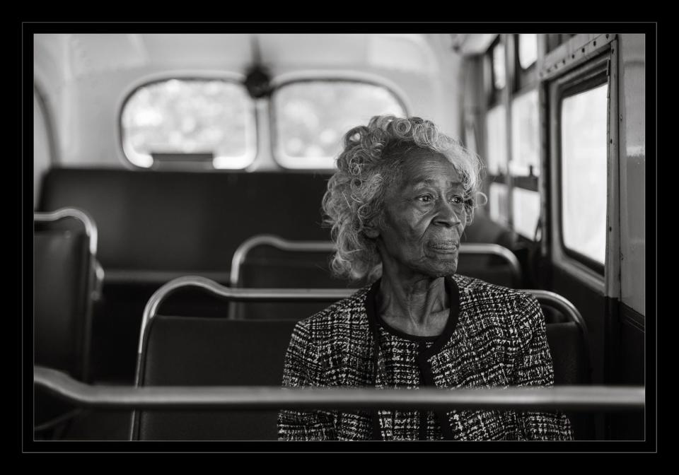"The Destination Ahead" by Gary D. Jones. His mother Azzie L. Jones peers out a window while seated on a bus at the Museum of Bus Transportation in Hershey, Pa.