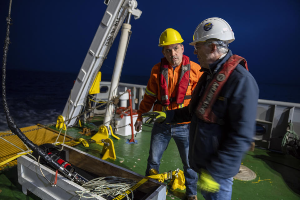 In this photo provided by Canadian Geographic Craig Bulger, left, Project Engineer, Fisheries and Marine Institute Memorial University of Newfoundland and David Mearns, Search Director, Blue Water Recoveries Ltd. prepare to launch the side-scan sonar tow fish to search for the missing Quest ship off the coast of Labrador, Canada, Sunday, June 9, 2024. The wreck of the last ship belonging to Sir Ernest Shackleton, a famous Irish-born British explorer of Antarctica, has been found 62 years after it went missing. The wreck was found by an international team led by the Royal Canadian Geographical Society. (Jill Heinerth/Canadian Geographic via AP)