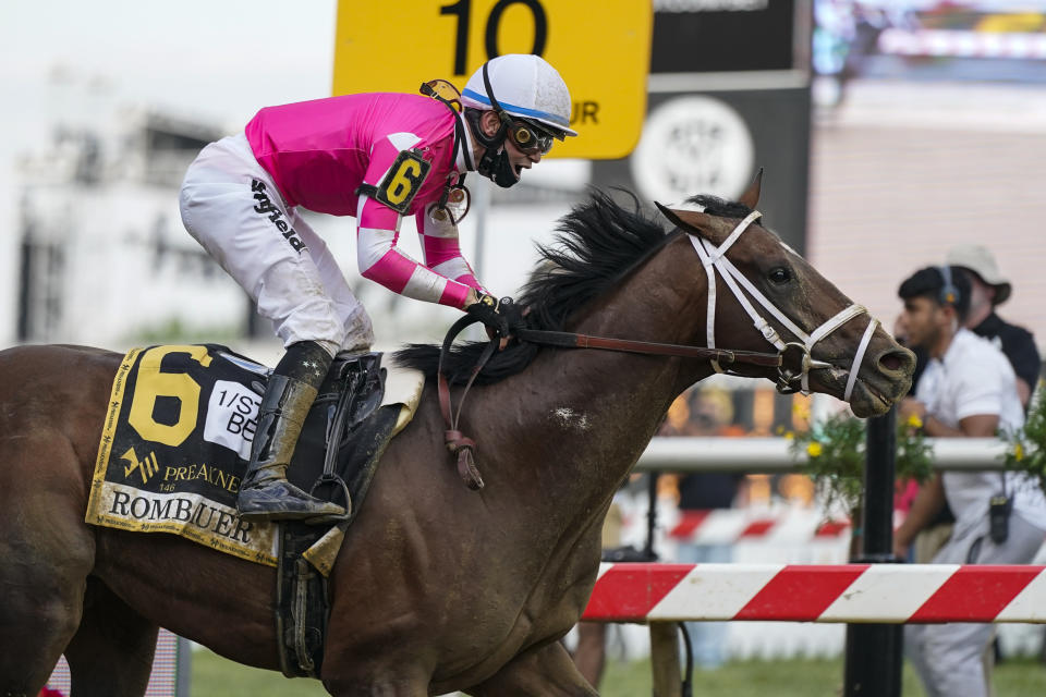 Flavien Prat atop Rombauer reacts as he crosses the finish line to win the Preakness Stakes horse race at Pimlico Race Course, Saturday, May 15, 2021, in Baltimore. (AP Photo/Julio Cortez)