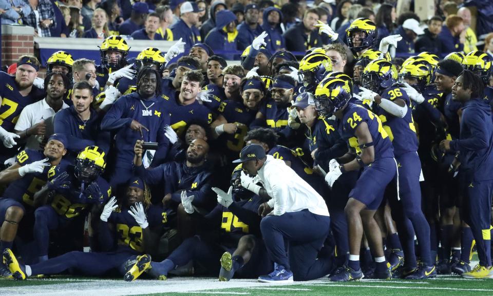 Michigan celebrate after an interception by defensive back Quinten Johnson during the first half of Michigan's 31-6 win on Saturday, Sept. 16 2023, in Ann Arbor.