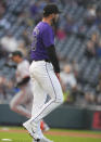 Colorado Rockies starting pitcher Peter Lambert waits after giving up a solo home run to San Francisco Giants' Michael Conforto, back, during the second inning of a baseball game Wednesday, May 8, 2024, in Denver. (AP Photo/David Zalubowski)