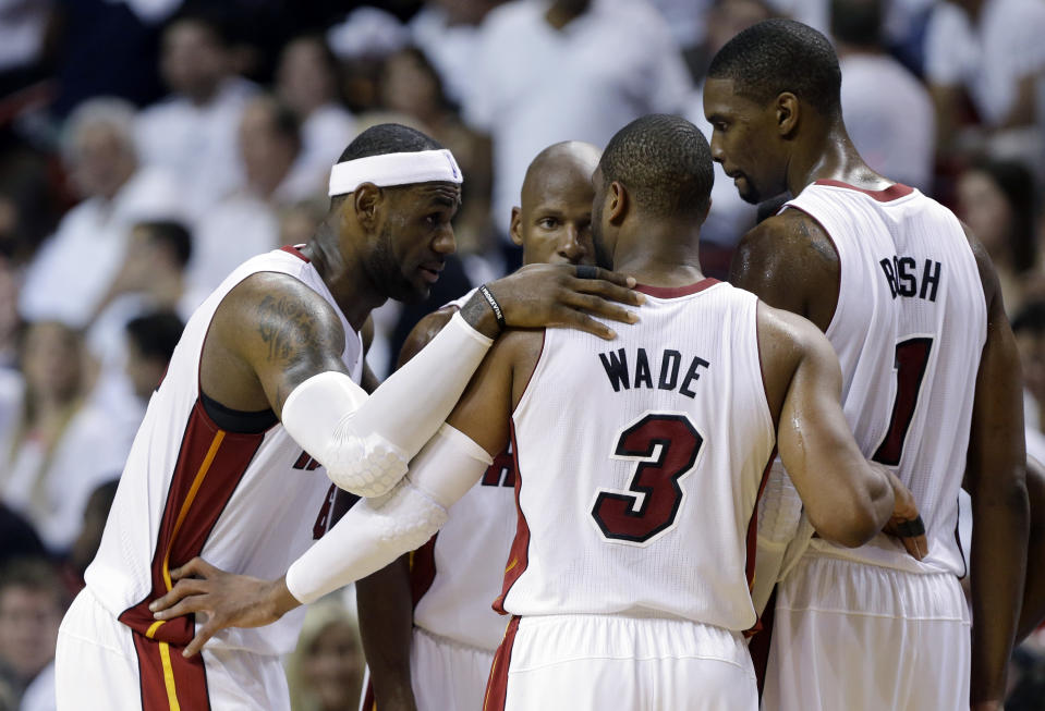 Miami Heat's LeBron James, left, Dwyane Wade (3), Chris Bosh (1) and Ray Allen, center, huddle on the court in the second half of Game 1 in an NBA basketball Eastern Conference semifinal playoff series against the Brooklyn Nets, Tuesday, May 6, 2014, in Miami. The Heat defeated the Nets 107-86. (AP Photo/Lynne Sladky)