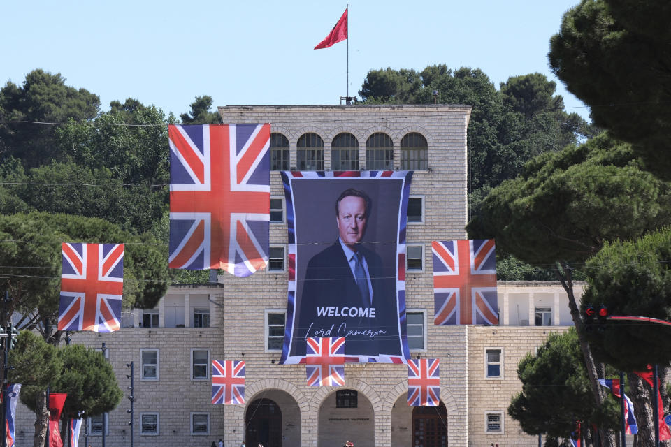 A portrait of British Foreign Secretary David Cameron is attached on a facade at the Tirana University, in Tirana, Albania, Wednesday, May 22, 2024. British Foreign Secretary David Cameron has hailed progress in a U.K.-Albania joint effort to cut illegal migration, saying small boat arrivals from Albania to the U.K. fell by over 90% in 2023, as the two countries fought people smuggling gangs. (AP Photo/Vlasov Sulaj)