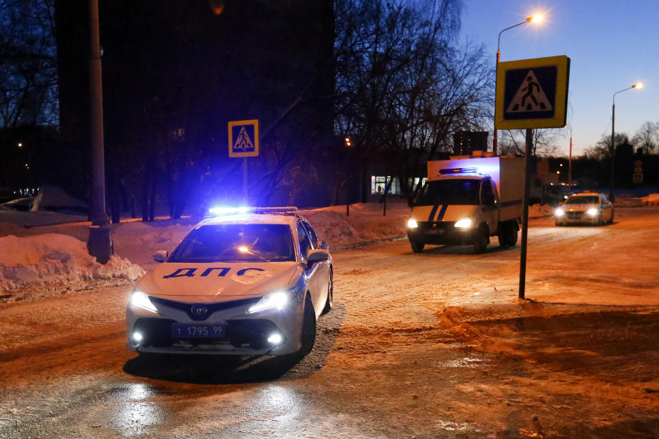 A Police van carrying the Russian opposition leader Alexey Navalny, escorted by police cars arrives to the Babushkinsky district court prior to the start of the trial in Moscow, Russia, early Tuesday, Feb. 16, 2021. Navalny is accused of defaming a World War II veteran who was featured in a video last year advertising constitutional amendments that allowed an extension of President Vladimir Putin's rule. (AP Photo/Alexander Zemlianichenko)