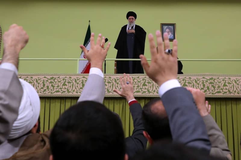 Iranian Supreme Leader Ayatollah Ali Khamenei stands as people greet him ahead of his annual speech to mark Persian New Year (Nowruz). -/Iranian Supreme Leader's Office/dpa