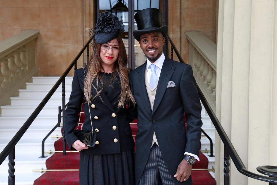 2017: Four-time Olympic champion Sir Mo Farah with wife Tania arriving at Buckingham Palace, London, where he will officially receive his knighthood from Queen Elizabeth II (PA )