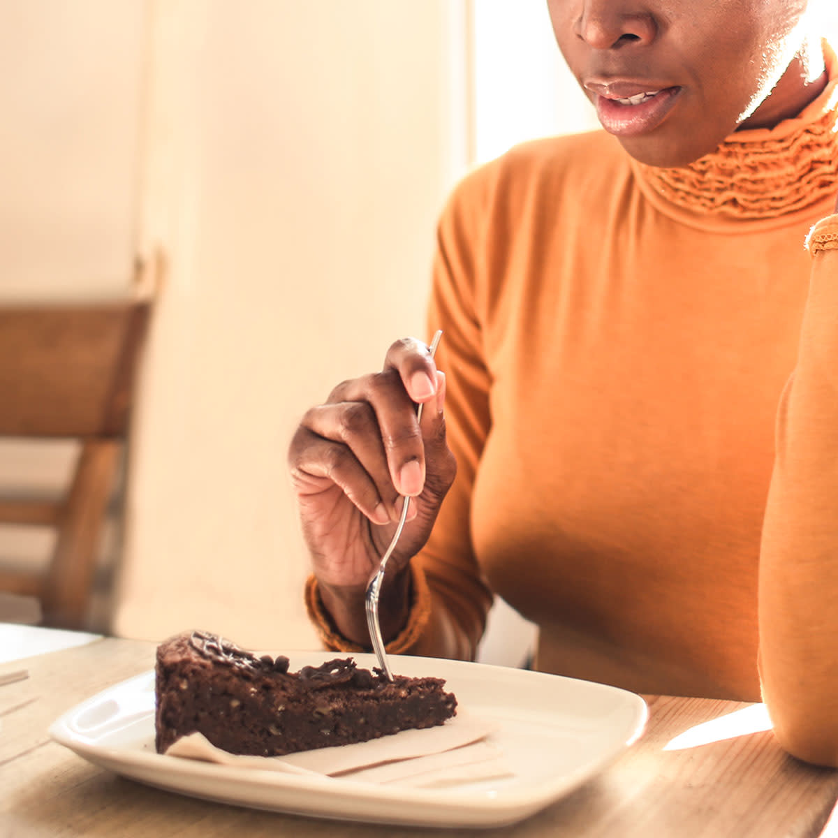 Woman eating a slice of chocolate cake