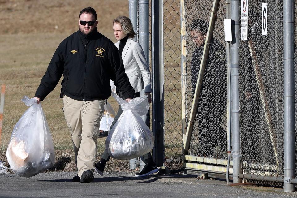 Michelle Carter, center, leaves the Bristol County jail, Thursday, Jan. 23, 2020, in Dartmouth, Mass., after serving most of a 15-month manslaughter sentence for urging her suicidal boyfriend to kill himself in 2014. The 23-year-old, released three months early for good behavior, will serve five years of probation.