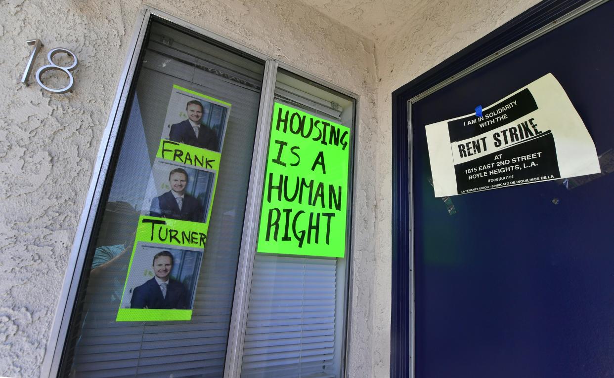 Signs and posters are seen on an apartment block where, with no rent control due to the year it was built, the landlord has increased some rents by as much as $800 in Boyle Heights, Los Angeles. (Photo: Frederic J. Brown/AFP/Getty Images)