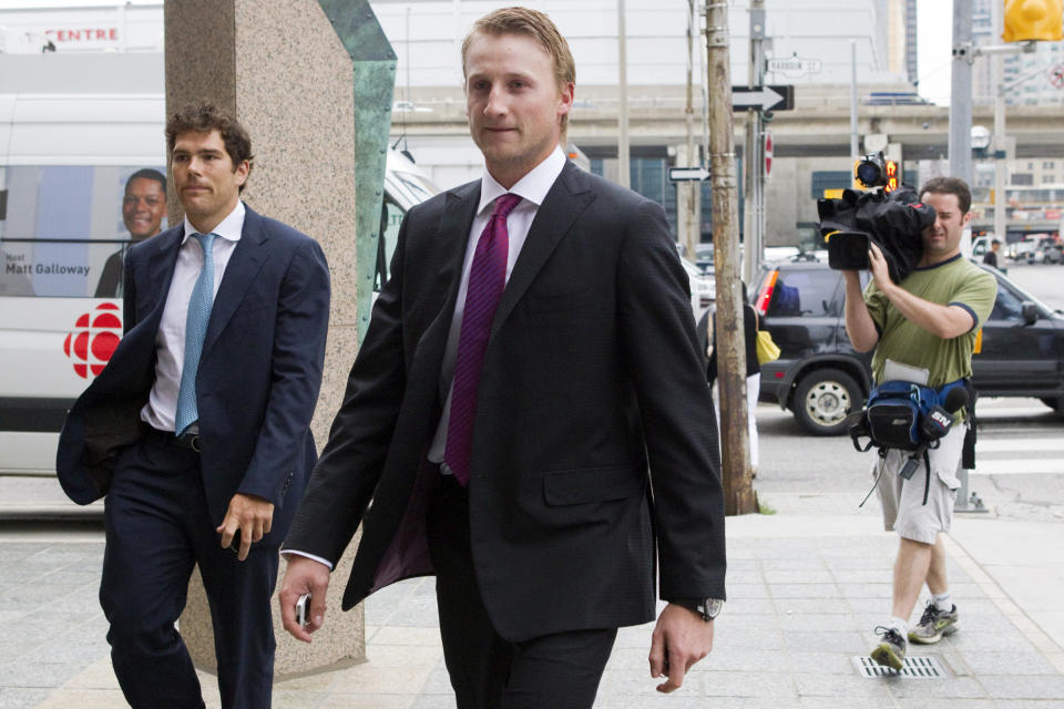 Tampa Bay Lightning's Steven Stamkos, center, and Colorado Avalanche's Steve Downie, left, arrive for collective bargaining talks in Toronto on Tuesday, Aug. 14, 2012. Negotiations continue between the NHL and the NHLPA to avoid a potential lockout. (AP Photo/The Canadian Press, Chris Young)