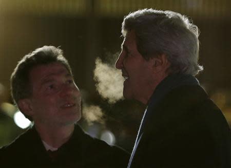 U.S. Secretary of State John Kerry (R) is welcomed by Charge de Affairs Peter Mulrean (L) to Geneva January 21, 2014. REUTERS/Gary Cameron