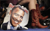 <p>Colorado delegate Tracy Ducharme from Colorado Springs wears cowboy boots as she sit next to her bag showing President Barack Obama during the Democratic National Convention in Charlotte, N.C., on Sept. 4, 2012. (AP Photo/David Goldman) </p>